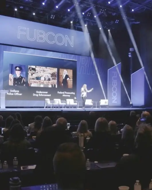 Pamela Barnum delivering a keynote on the FUBCON main stage in front of a packed audience